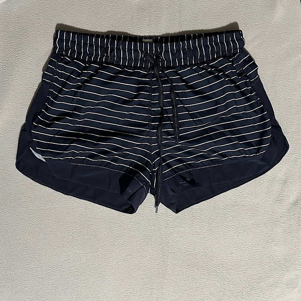 Dip Shorts. Navy Blue with white stripes. Mesh seam at the bottom.